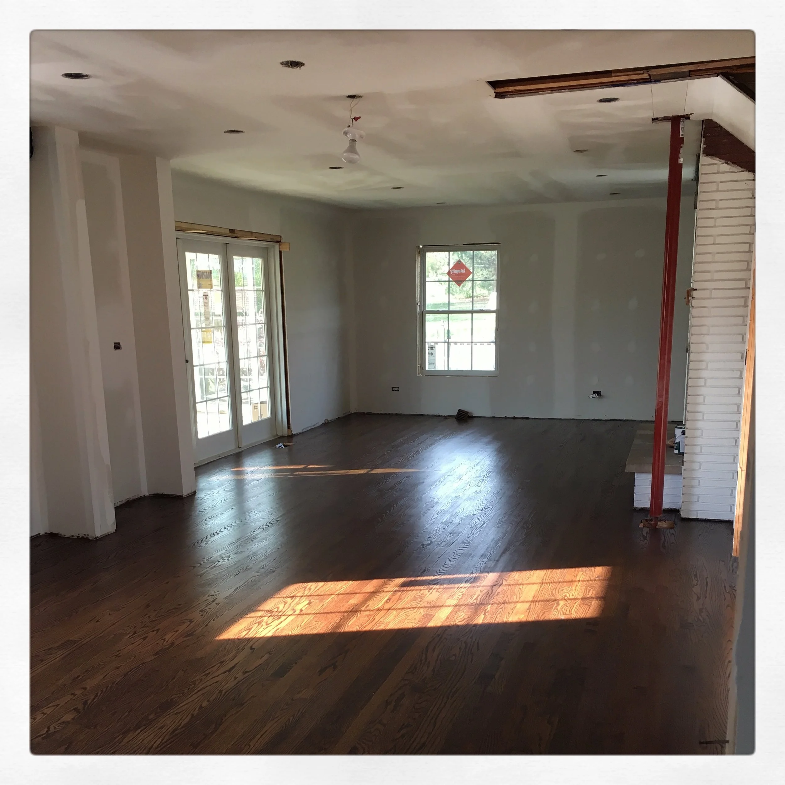 We enclosed some of our vertical plumbing lines on the left, our new structural column on the right! Our medium walnut stain went on to match the floors throughout the rest of the house that we had refinished when we moved in. 