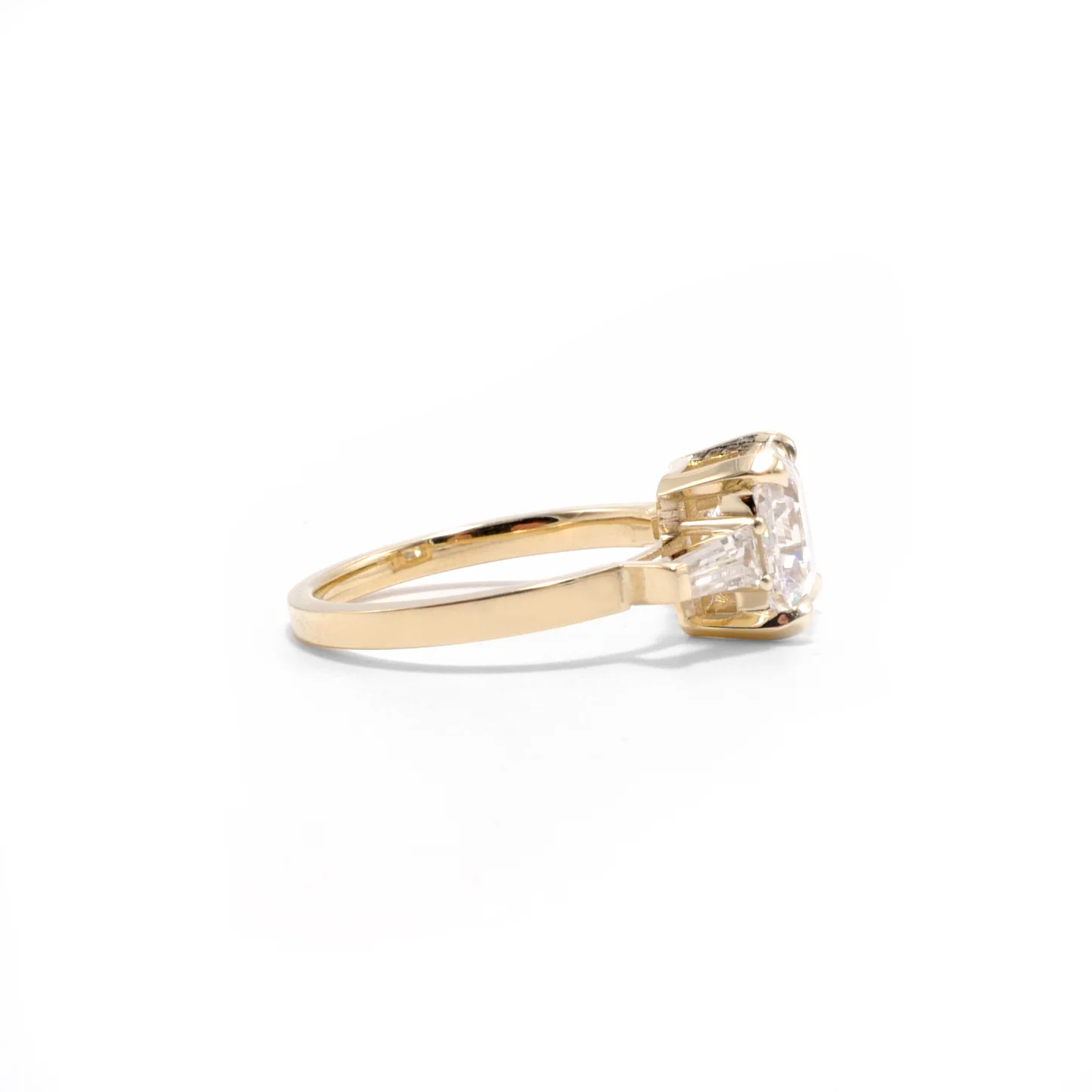 asscher cut diamond three stone ring.