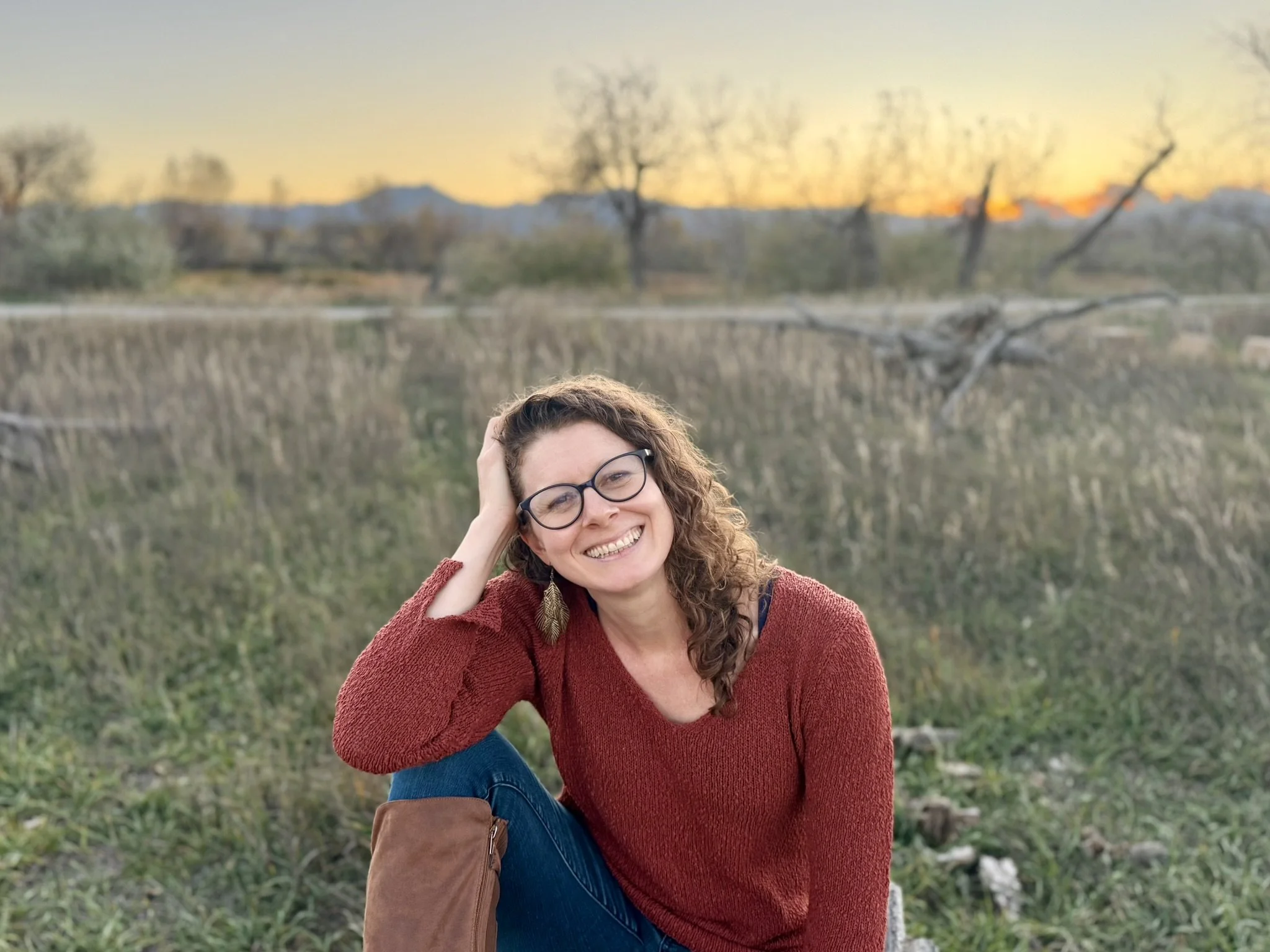Becky Howie, MA, LPC sitting outside at sunset