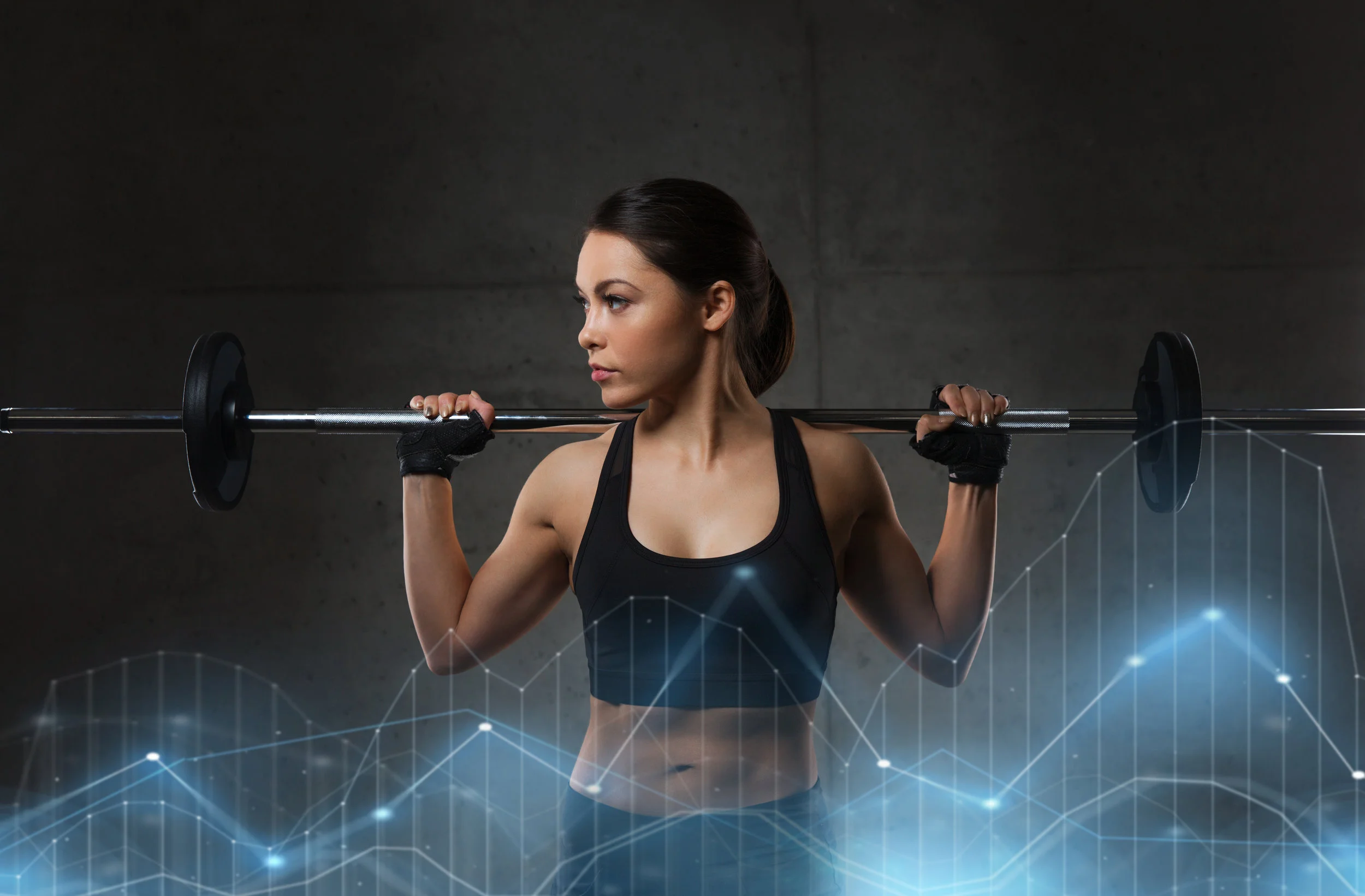 young-woman-flexing-muscles-with-barbell-in-gym-PNEZ2UA.jpg