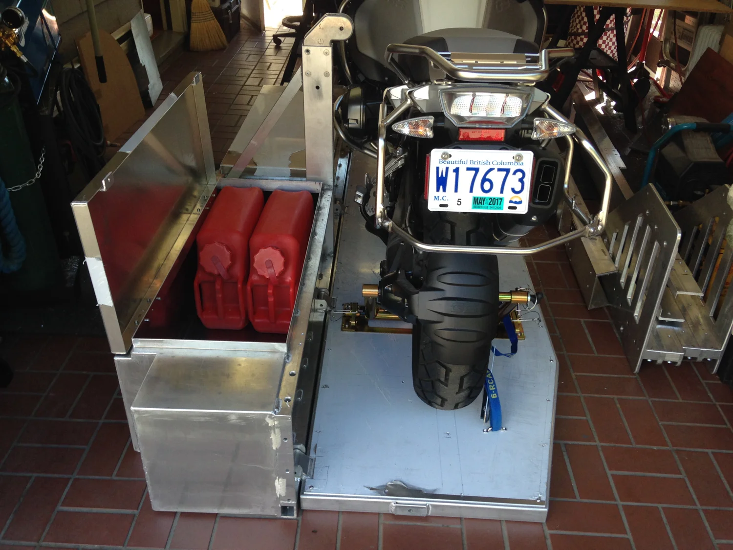 The storage box lid in the open position showing how the fuel cans fit in.