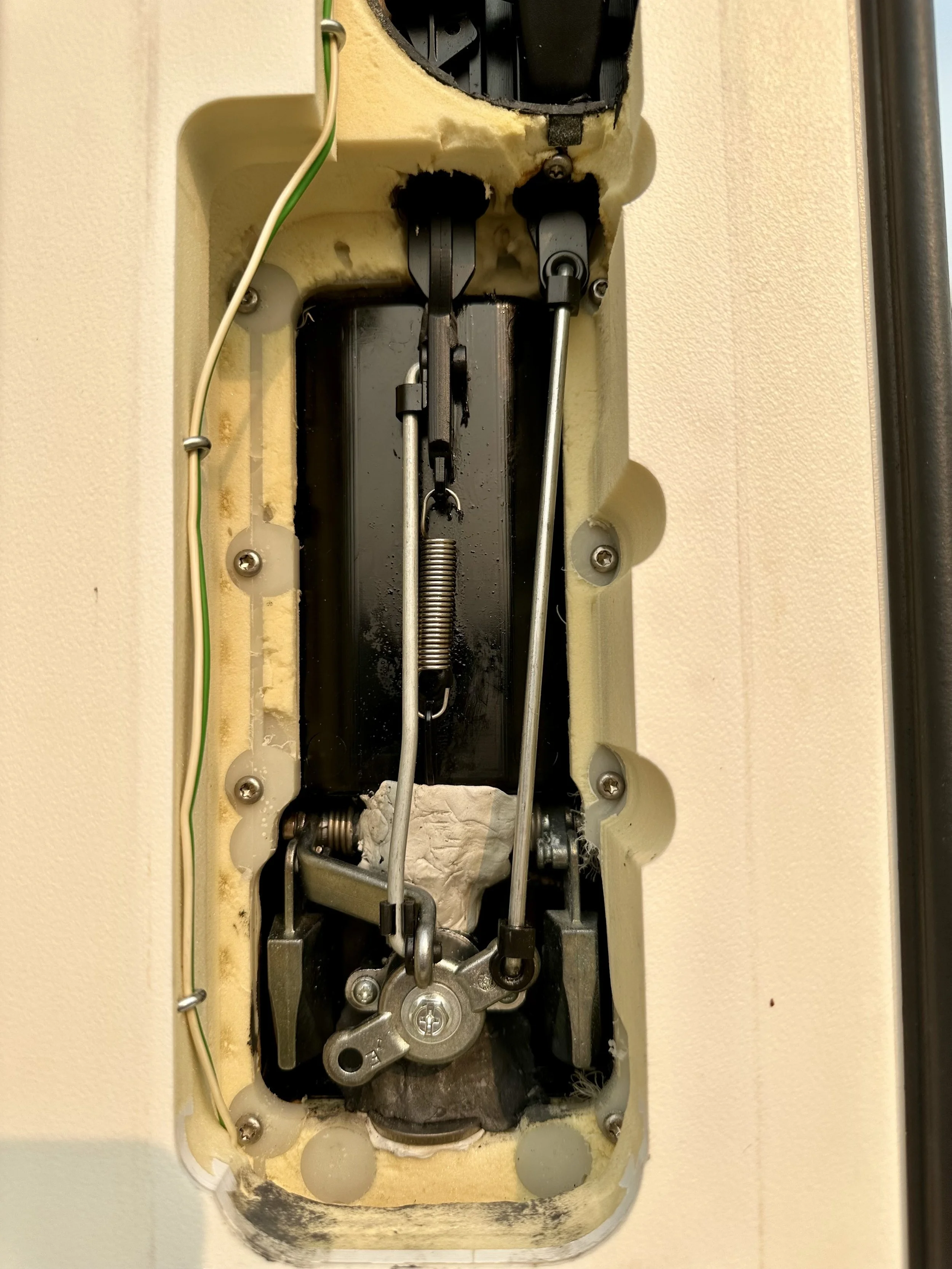   The inside of the outer handle mechanism. An attempt was made to fix the fractured plastic housing in the field using JB Weld epoxy putty. It didn’t work.  