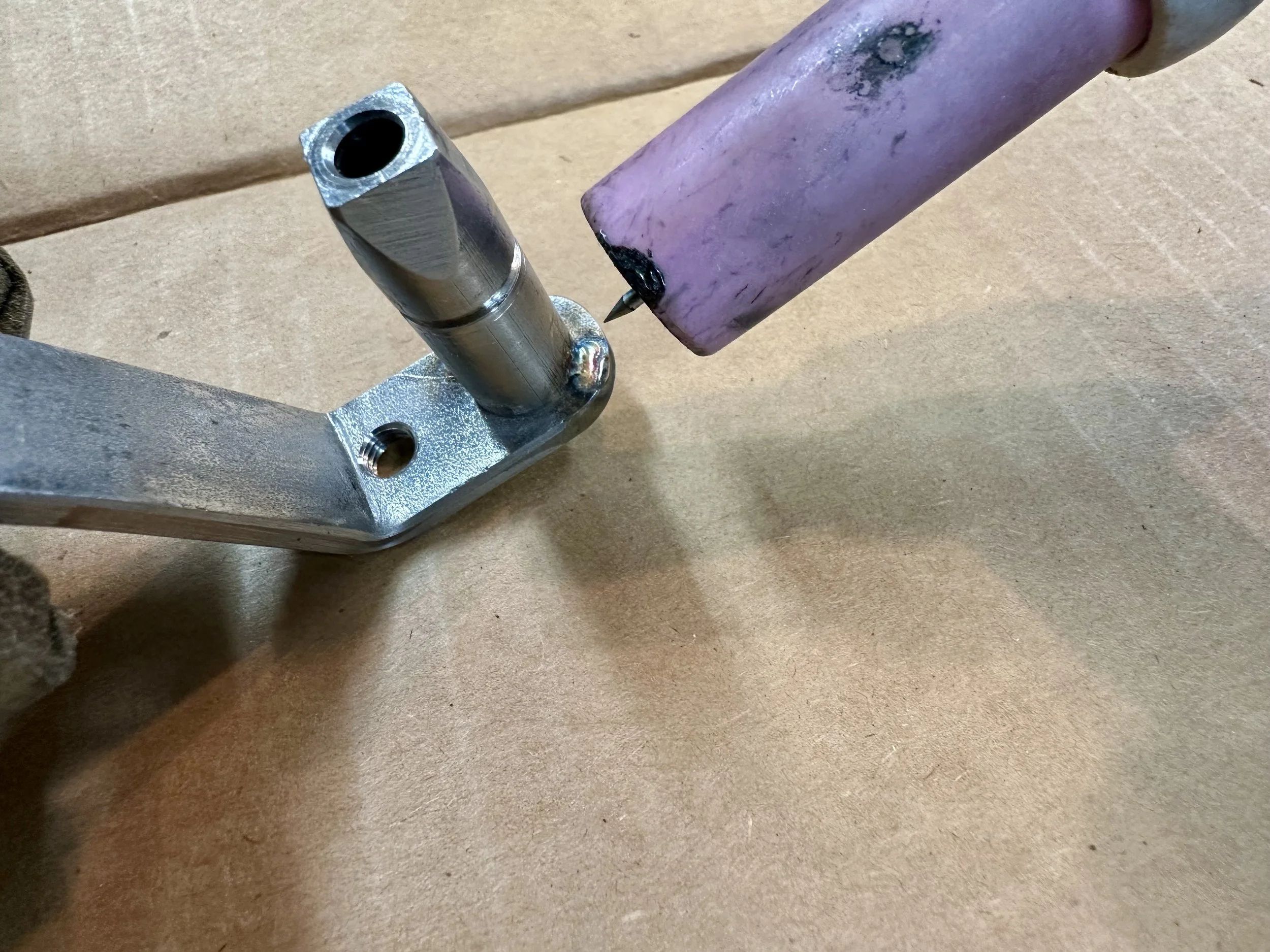   With the curvature ground to shape, the shaft was tacked on using the TIG welder. The full mechanism was then reassembled and installed back in the door to determine if I got the rotational lever angle correct. If it wasn’t right, the shaft would h