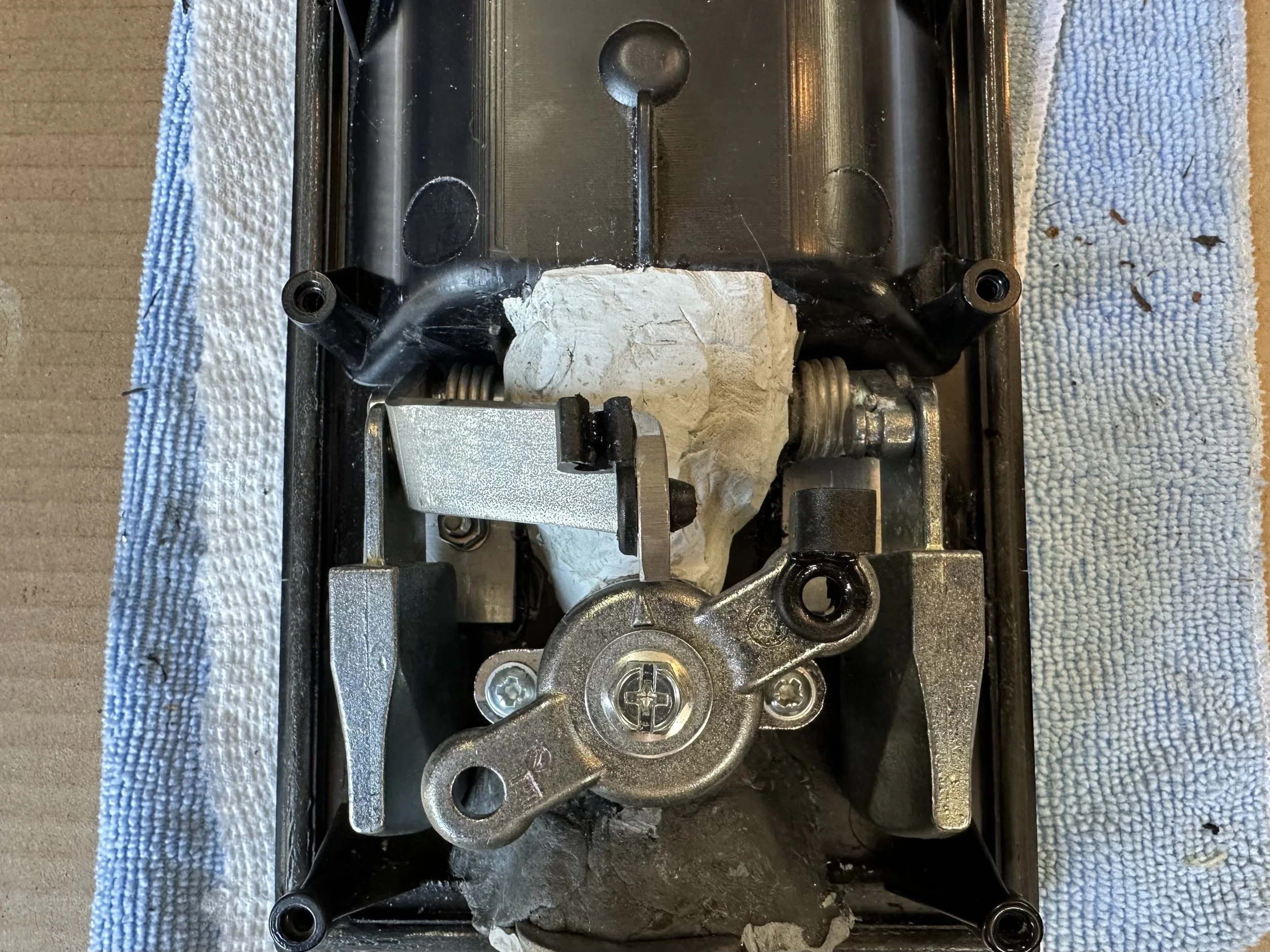   The latch lifter (the flatbar piece) is dead centre like the original. The epoxy putty is being left in place as it does do a good job of reinforcing the pivot housing. Job done.  