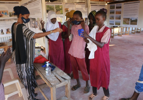 Lattu Lifespring distributes face masks to children.