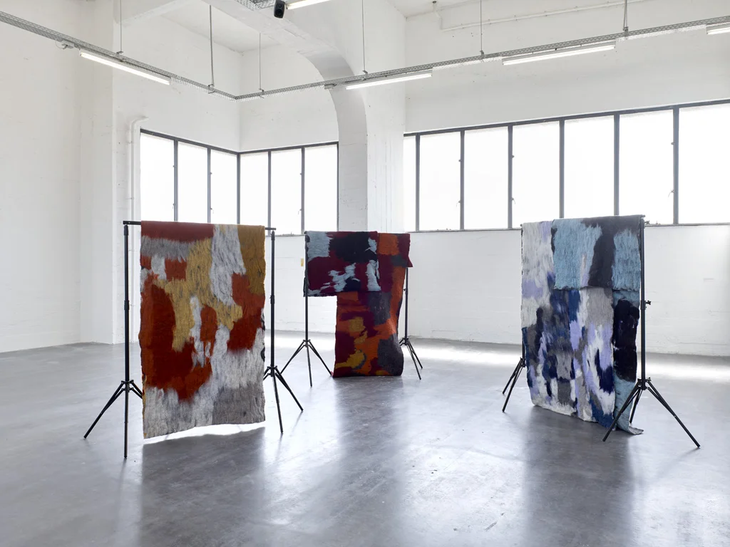 txt, Is Not Written Plain (draft III), with Globe Aroma, 2017. Audio installation with 12 handmade felts on metal backdrop stands. Installation view Hana Miletić: Dependencies, WIELS, Brussels, 2018 © Kristien Daem
