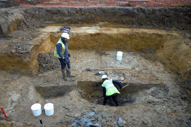 Excavation of a Roman well in an area of specialist cattle-butchery