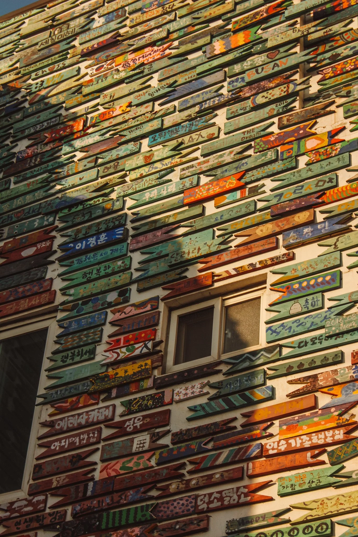 Exploring Gamcheon Village with gimbap, tteokbokki, cozy cafés, and postcard views over Busan’s coastline