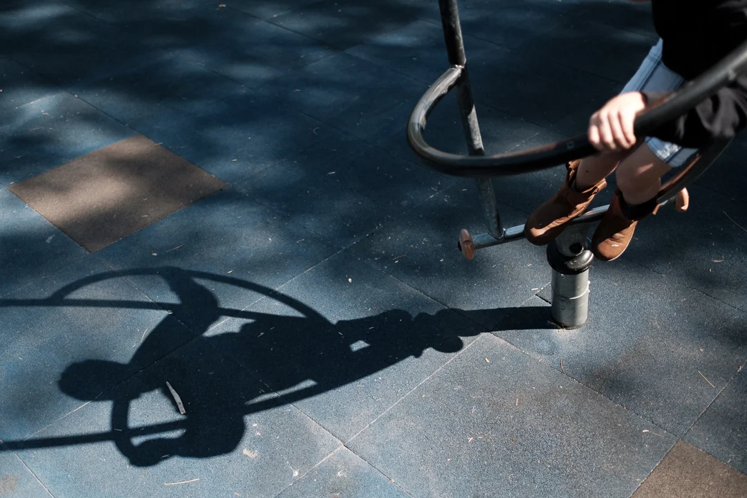 A documentary photo of a boy playing on playground equipment in San Dimas, CA