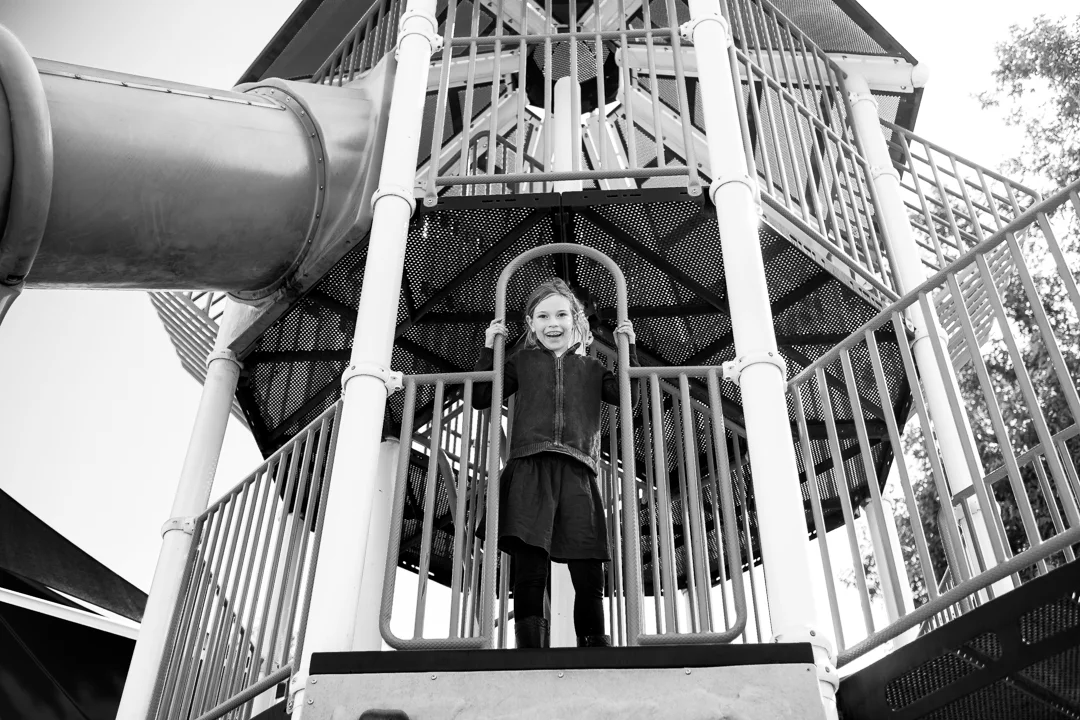 This is a fun black and white photo of a girl on playground equipment in San Dimas, CA by Erica Faith Photography.