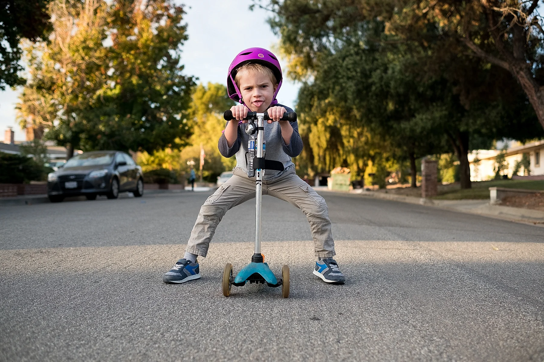A candid documentary photo of a boy on his scooter in Claremont, CA taken by Erica Faith Walker.