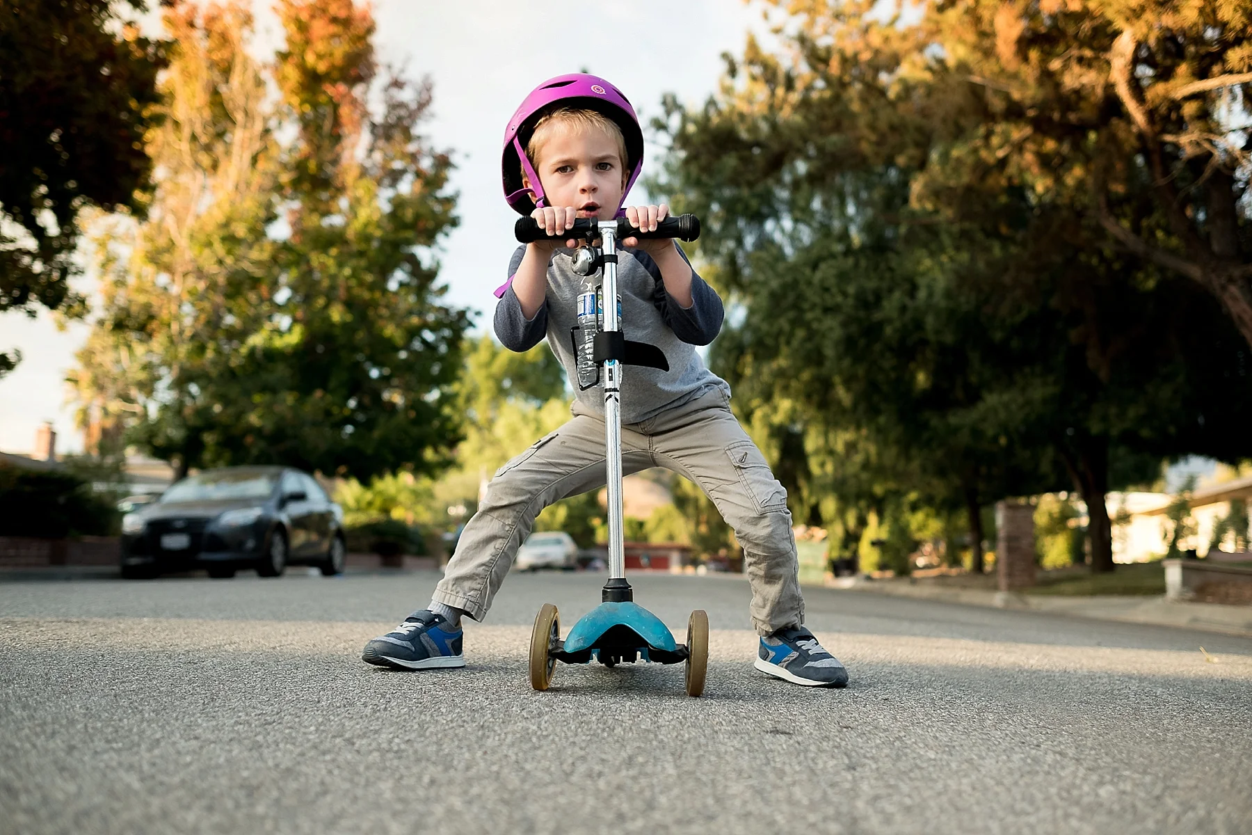 Candid and documentary photo of a boy posing with his scooter in Claremont, CA taken by Erica Faith Photography.