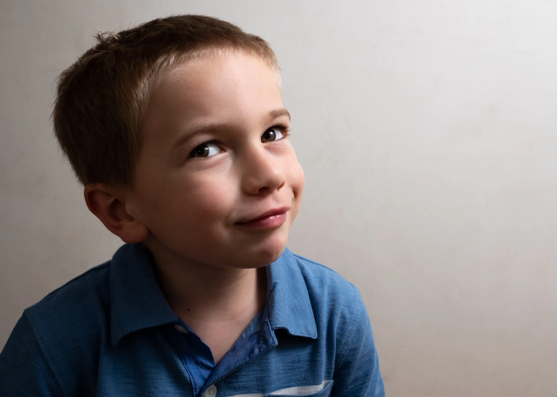 Portrait photography of a young boy makes great use of shadows.