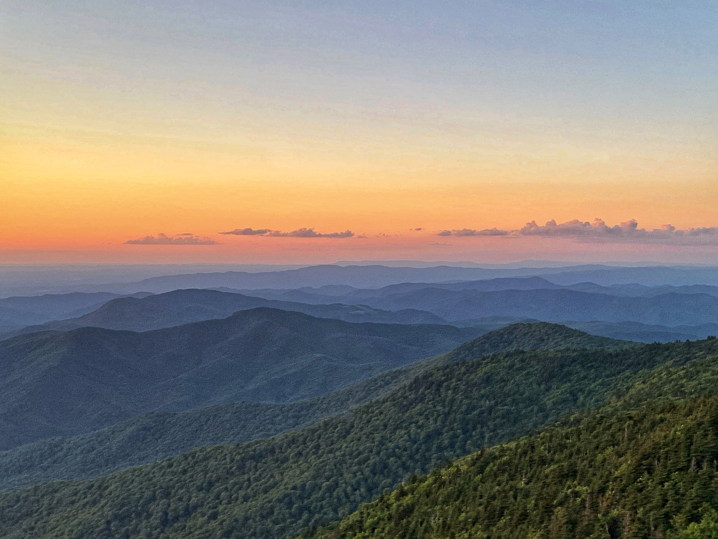 Sunset over layered Blue Ridge Mountain silhouettes