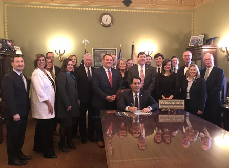 Executive Director Brad Boycks and Immediate Past President David Belman attended bill signing.