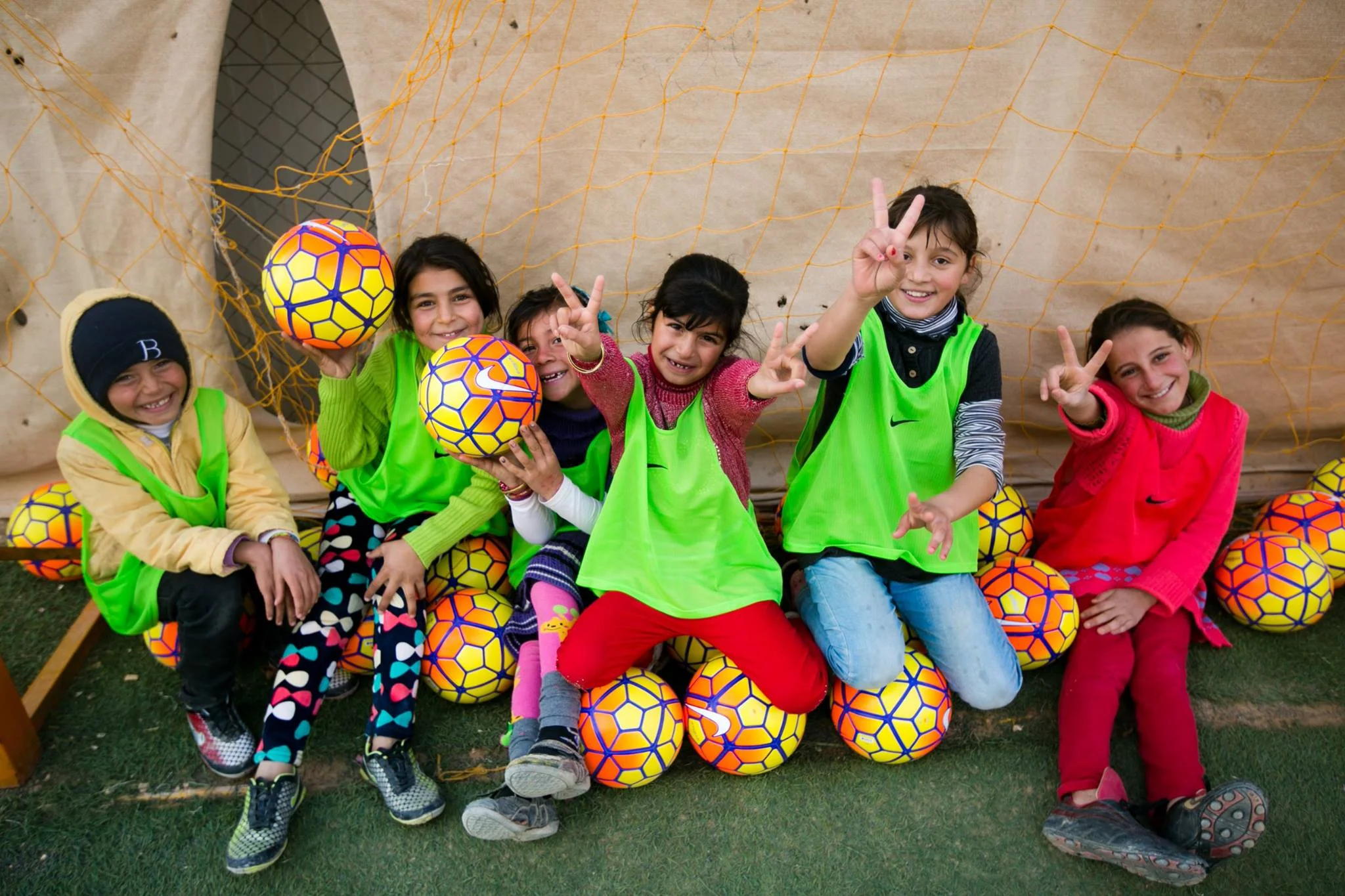 Youth in Jordan celebrate with donated equipment from U.S. Soccer after participating in sports clinics lead by Global Sports Mentoring Alumnae and Mentors. Photo courtesy of Center for Sport, Peace, and Society at the University of Tennessee. 2015. 