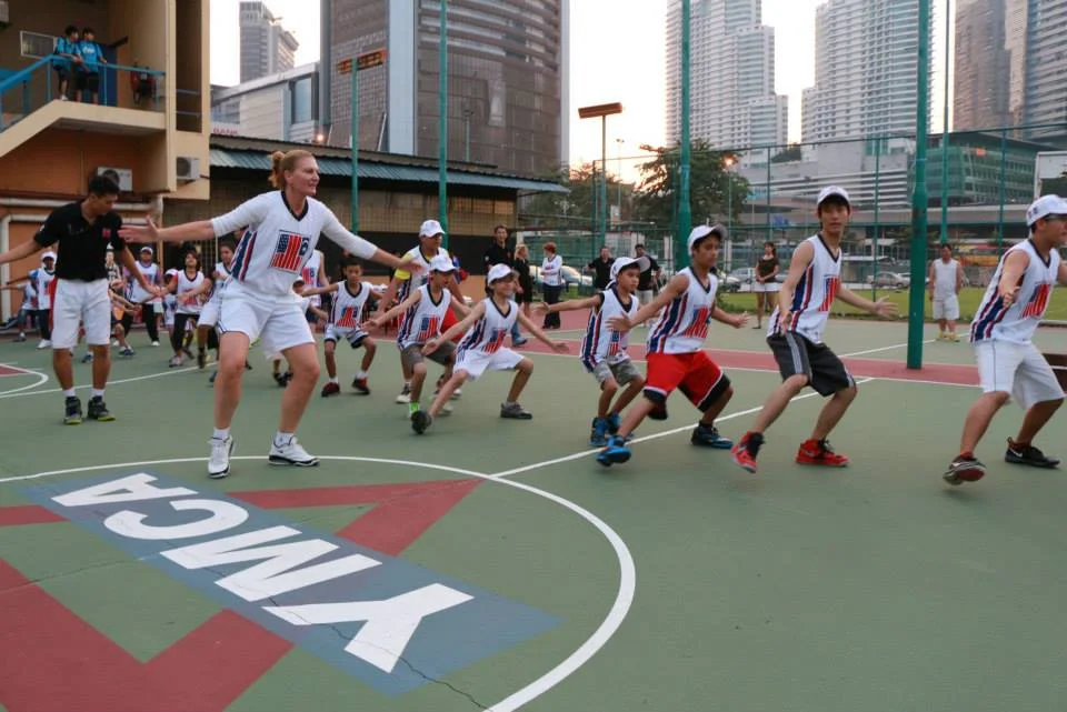 Sports Envoy and former WNBA player, Sue Wicks, leads defensive drills for youth in Malaysia. 2013. 