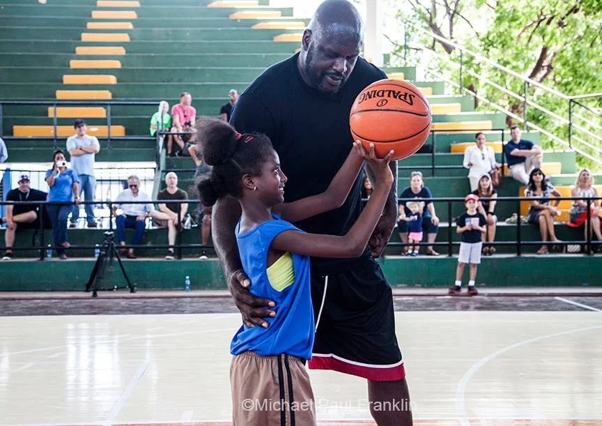 Sports Envoy and NBA legend Shaquille O’Neal instructs a Cuban youth player in shooting technique. 2016. Photo courtesy of Michael Paul Franklin.