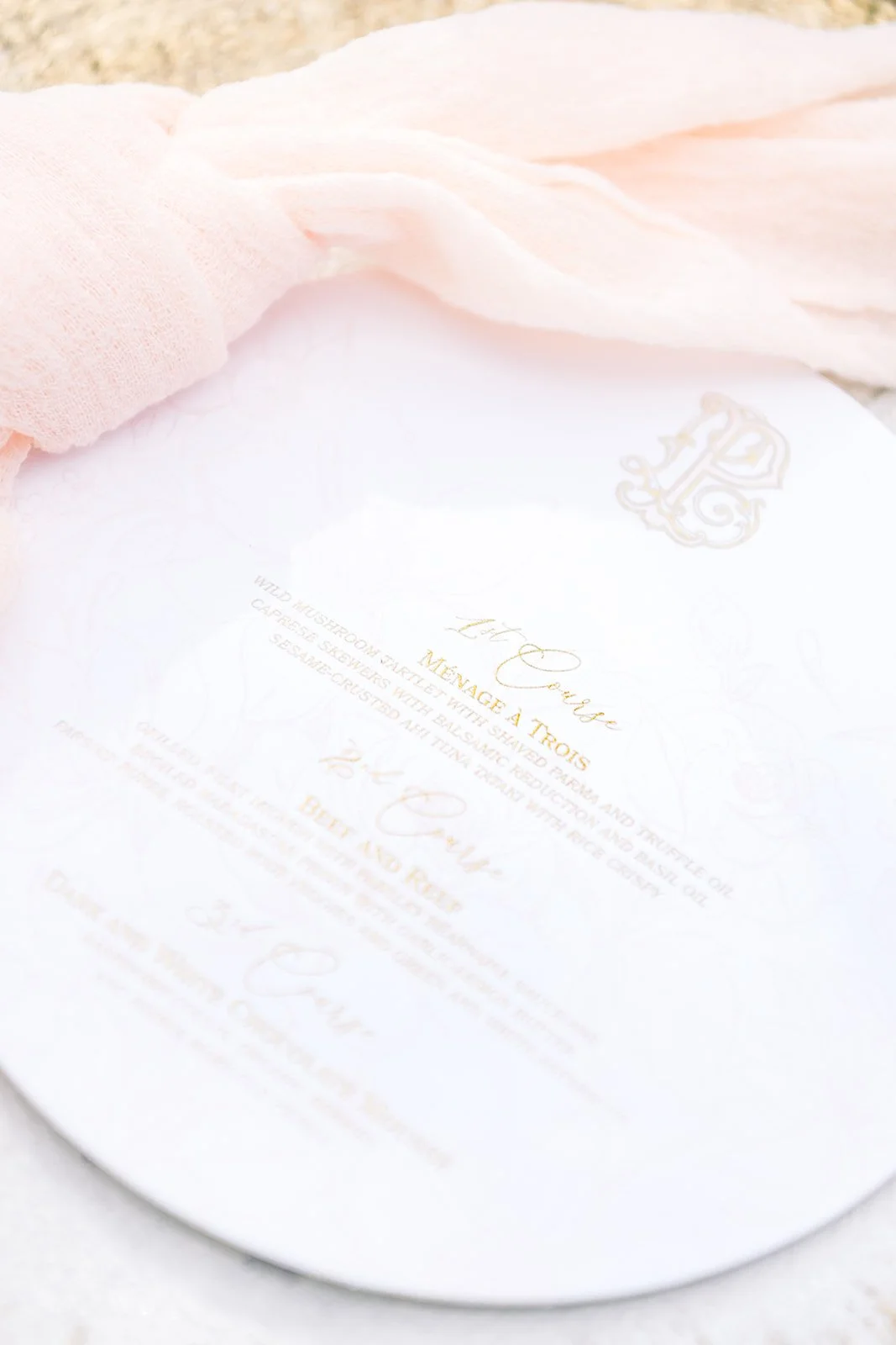 Engraved menu on fine white paper with elegant black typography and gold detailing, illustrating a refined expression of wedding stationery craftsmanship.