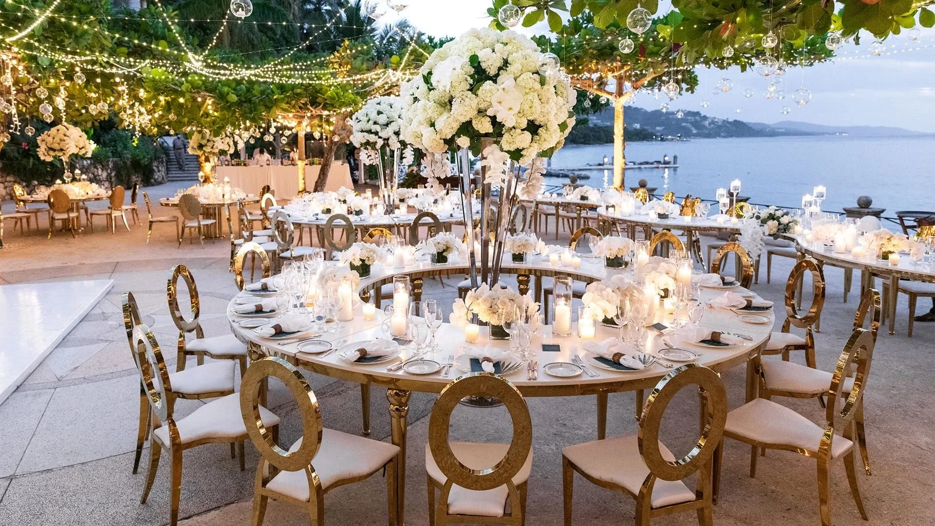 Outdoor wedding reception at Round Hill in Jamaica, with candlelit tables and tropical surroundings creating an intimate evening setting.