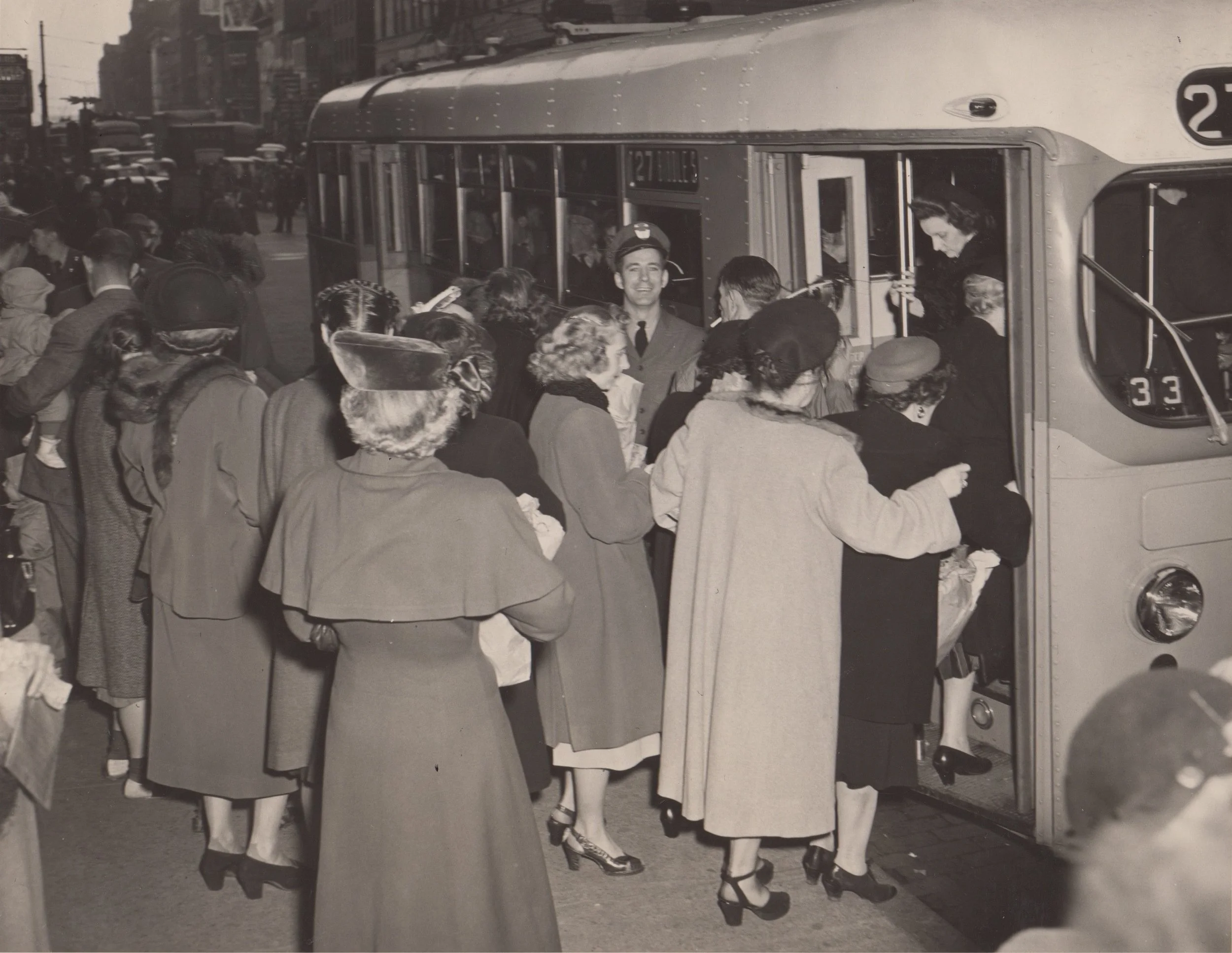 Boarding a trackless trolley in the late 1940s. Image Credit: BSM Archives