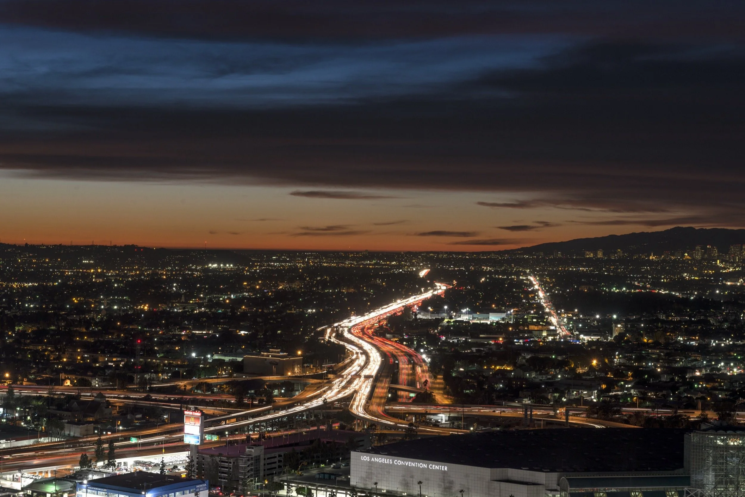 Los Angeles skyline at dusk over the Santa Monica Freeway