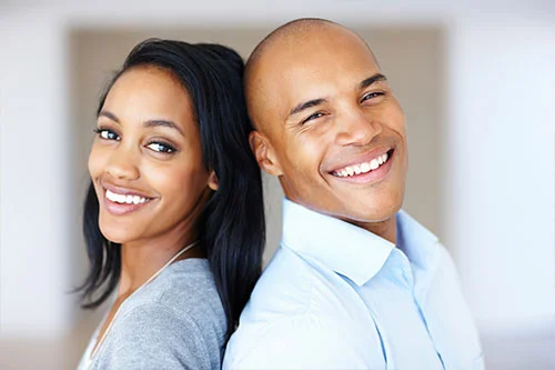 Couple smiling back to back