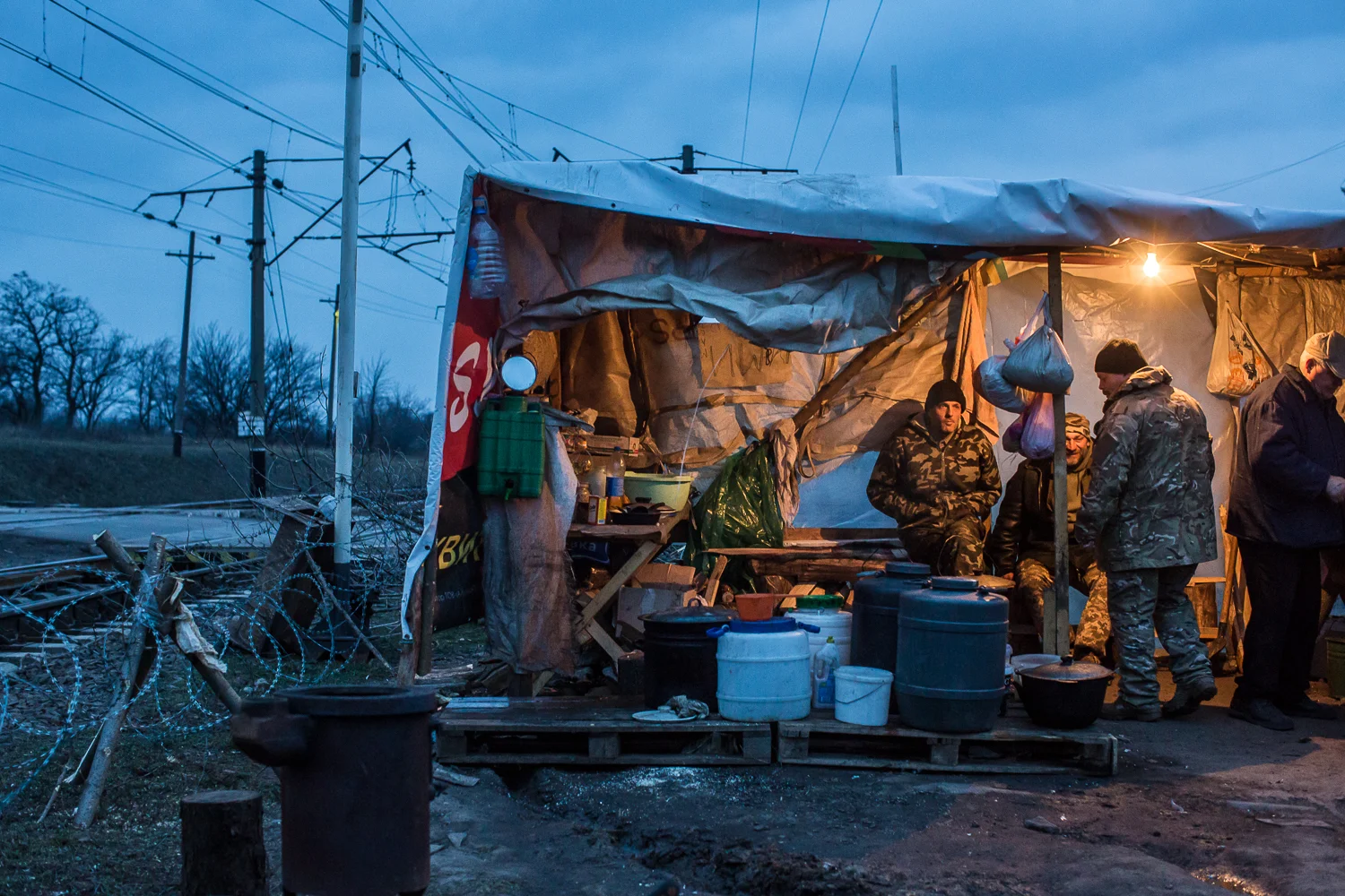 Activists, including war veterans, seat in a makeshift kitchen at a rail blockade in Kryvyi Torets railway station in the village of Shcherbynivka, Donetsk region, Ukraine on March 12, 2017