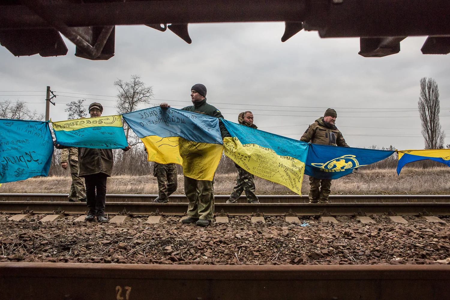 Activists take down Ukrainian flags brought by supporters from a blocked train carrying coal in Kryvyi Torets railway station in the village of Shcherbynivka, Donetsk region, Ukraine on March 12, 2017