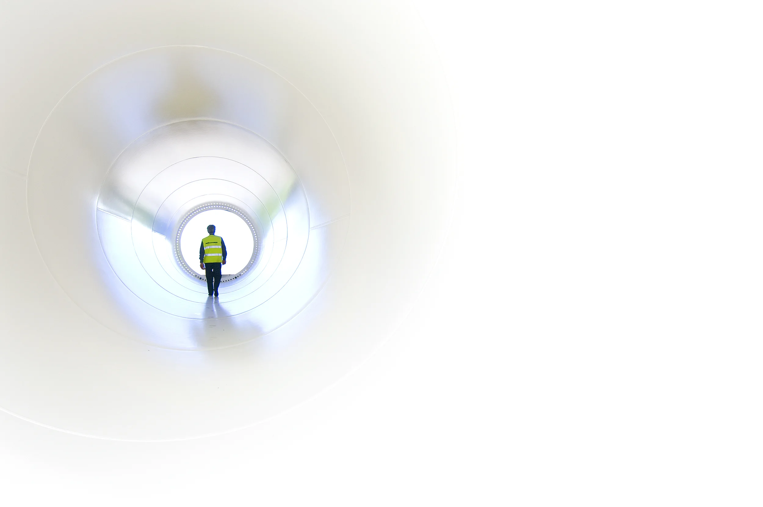 Engineer inspecting interior of wind tower at Vestas Wind Systems plant in Randers (Denmark).
