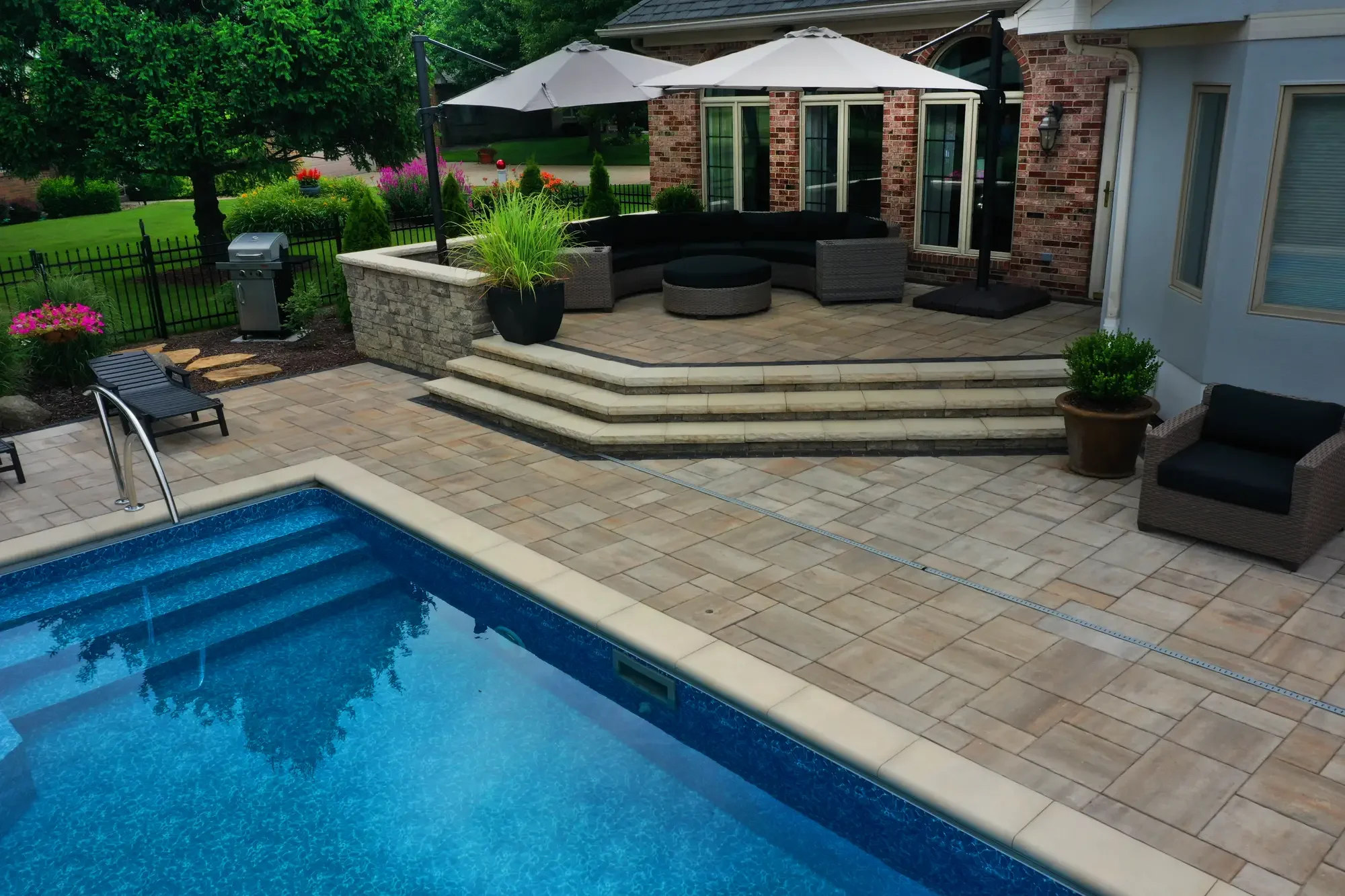 Paver pool surround with raised stone terrace and steps by Green View in Illinois