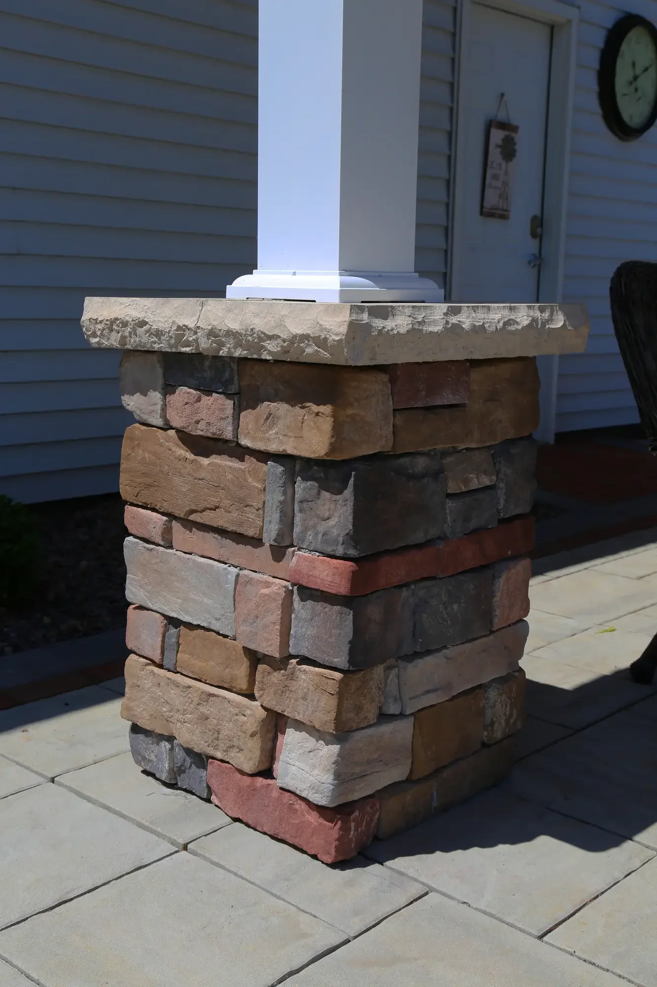Close-up of stacked stone column base with white post at The Prairie Pavilion by Green View in Illinois
