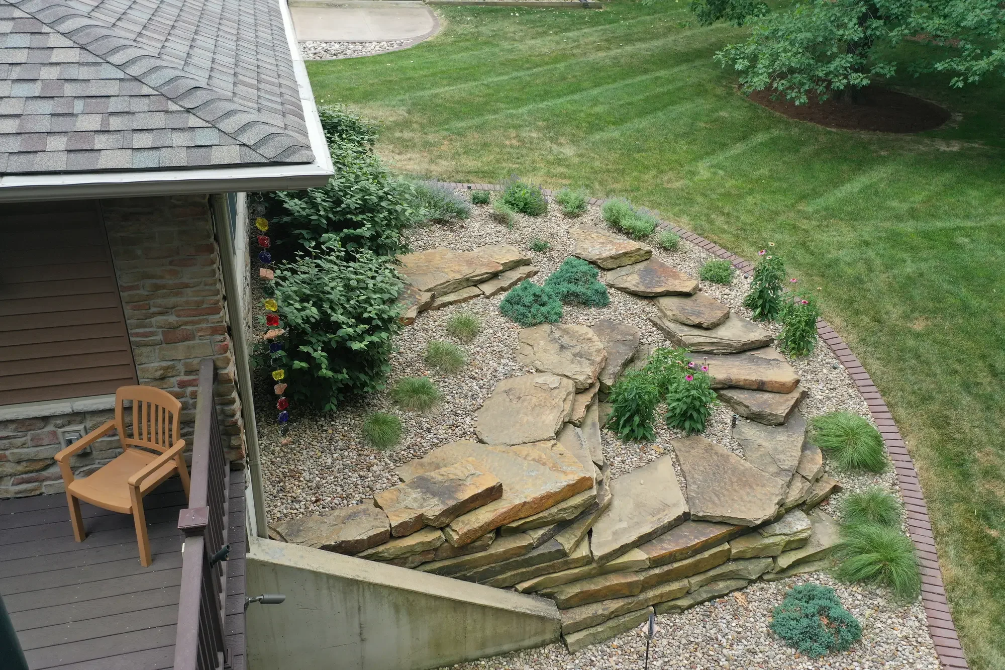Aerial view of flagstone stepping stone path through gravel garden bed with brick border by Green View in Central Illinois