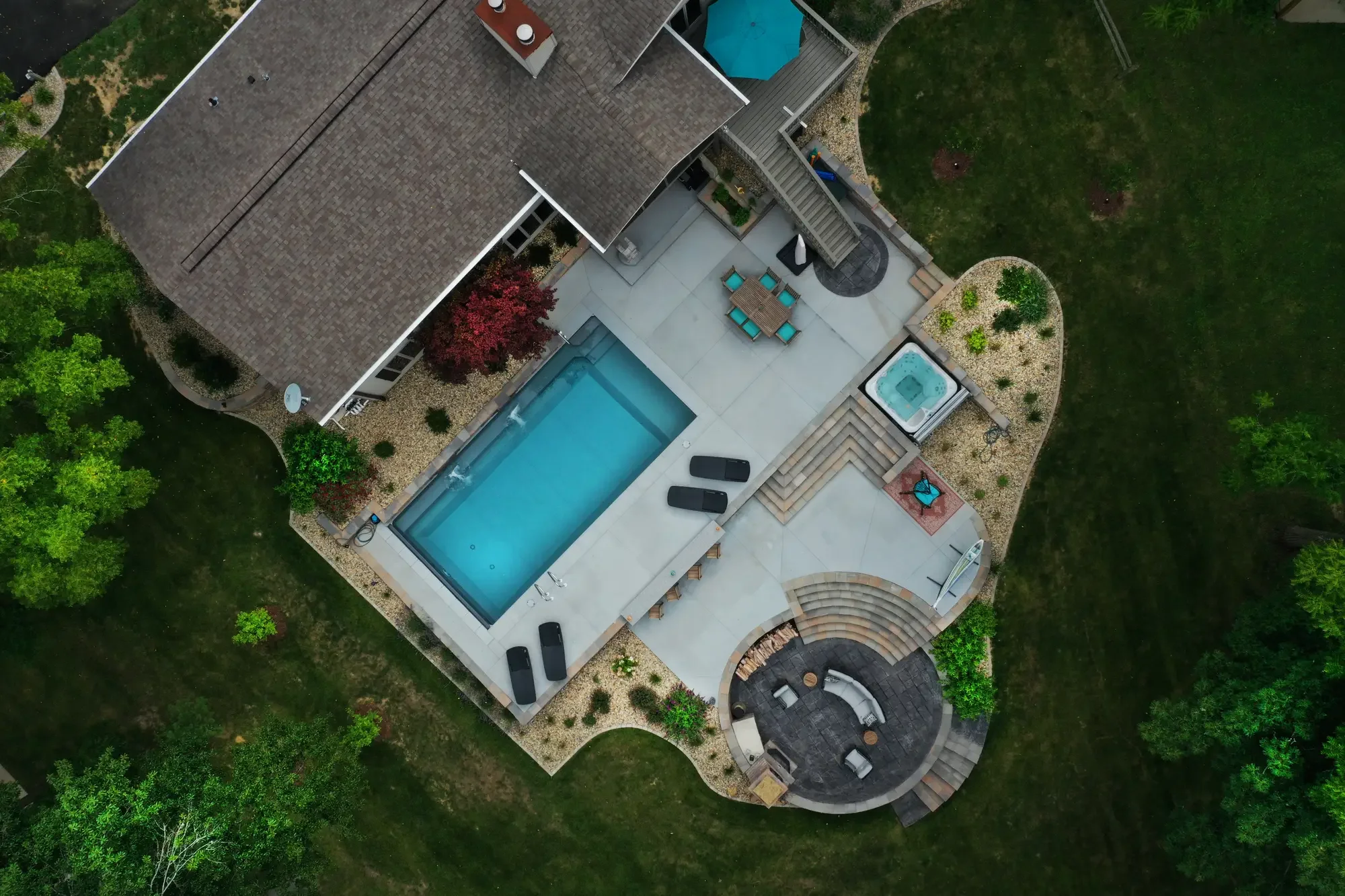 erial view of pool surround, curved amphitheater steps, and sunken fireplace patio at The Amphitheater by Green View in Illinois
