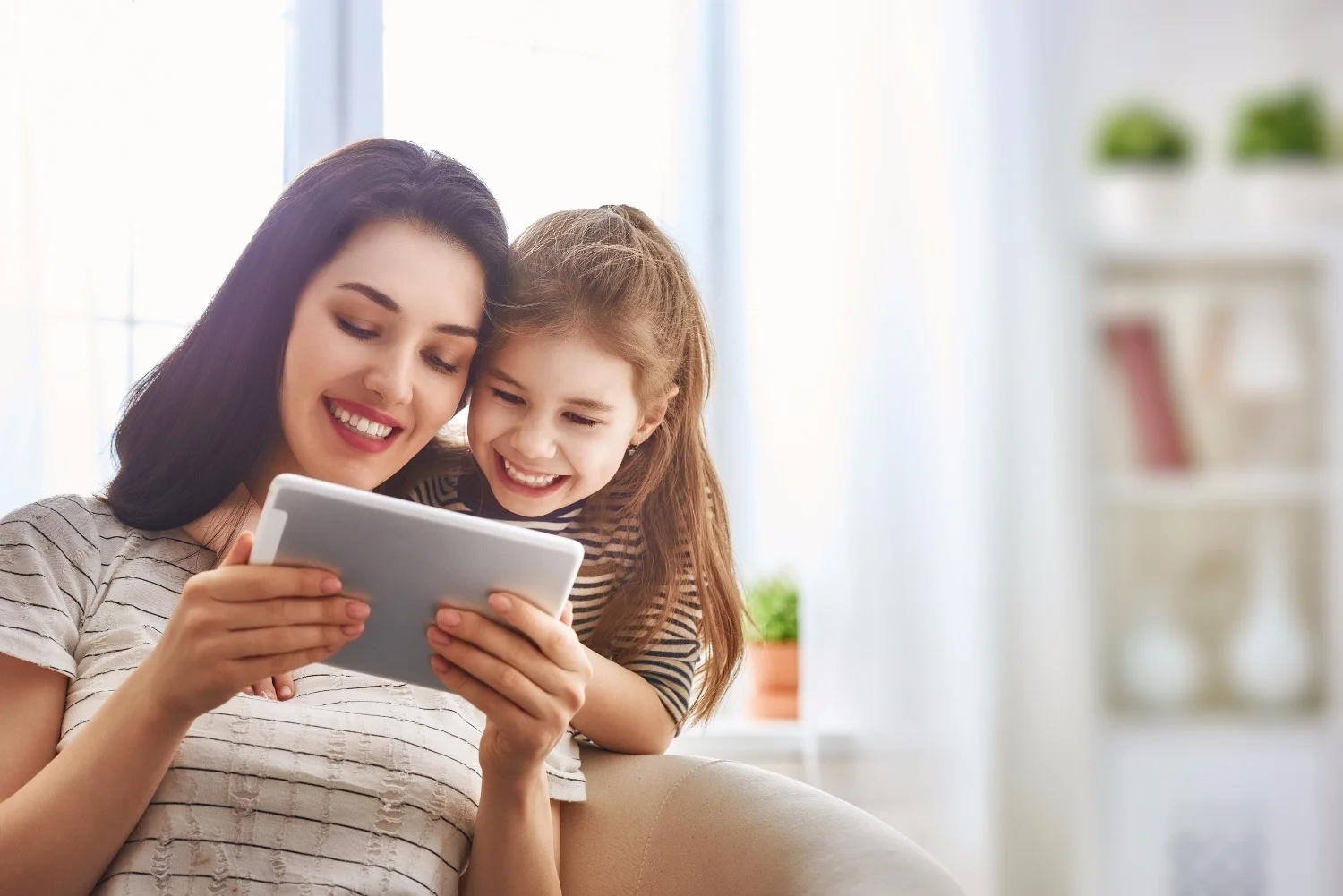 Happy loving family. Young mother and her daughter girl play in kids room. Funny mom and lovely chil_edited.jpg