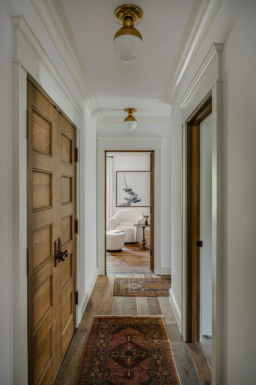 Wide plank reclaimed white oak flooring in Palo Alto Craftsman hallway with vintage Persian rugs and solid brass ceiling fixtures by California Wood Floors