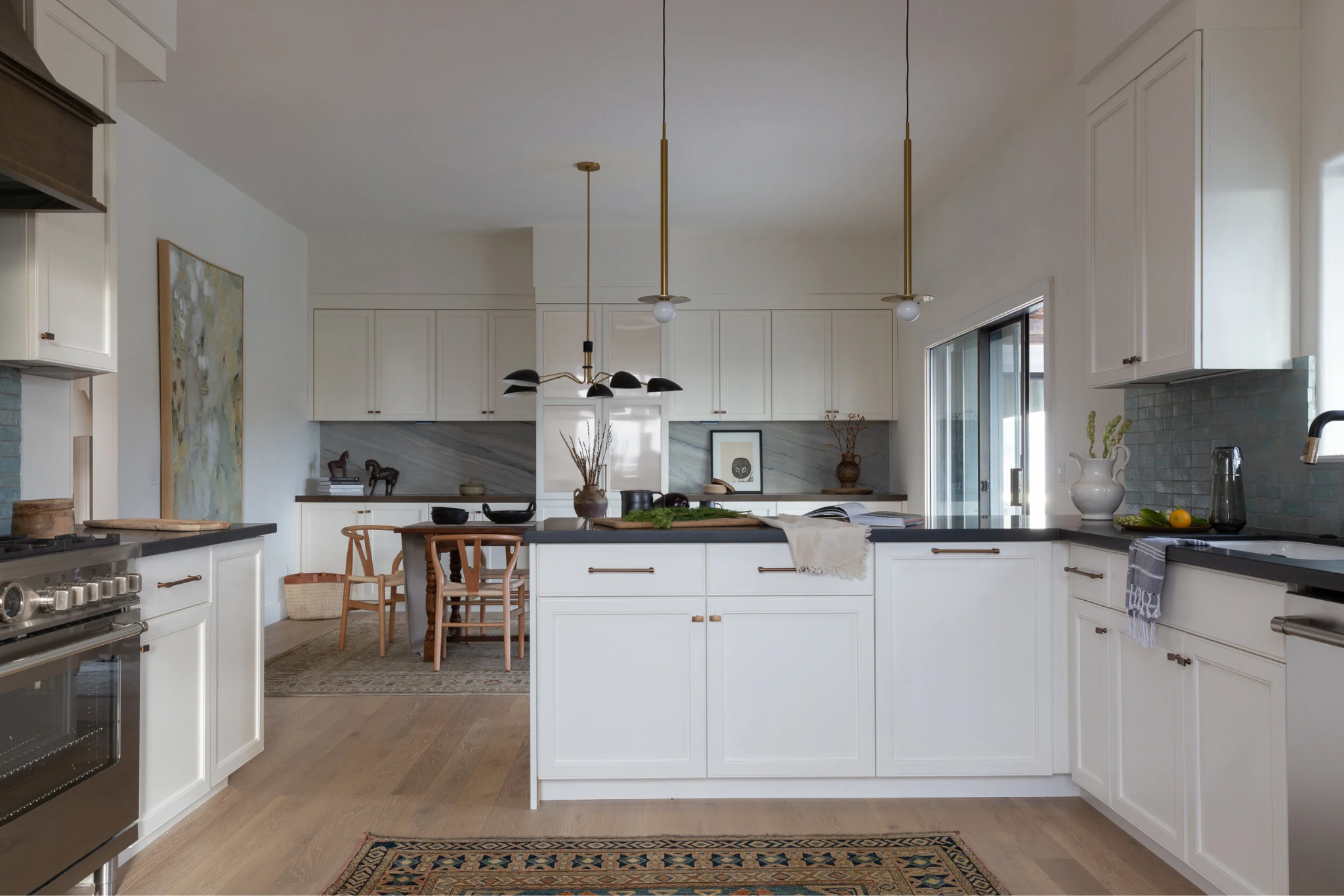 Modern white kitchen with handcrafted brass pendant lighting in a Palo Alto Craftsman renovation by Lane McNab Interiors