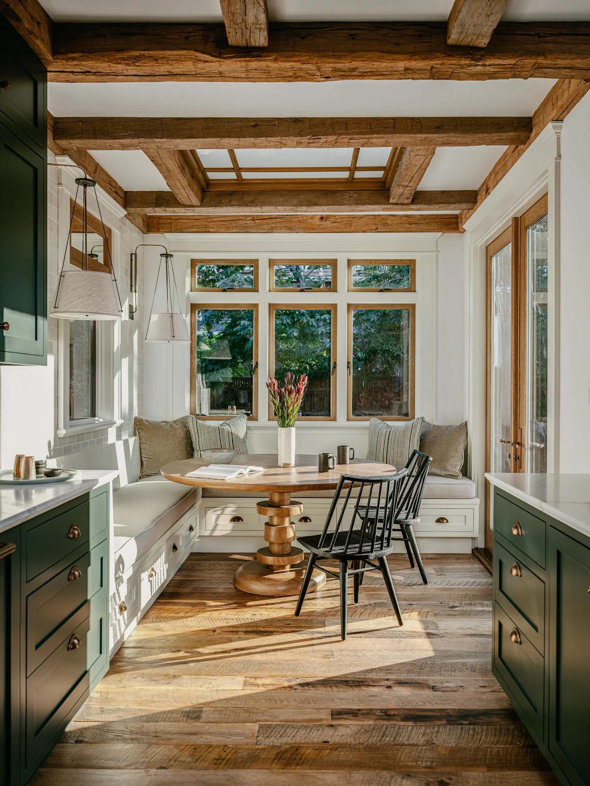 Palo Alto Craftsman kitchen featuring centuries-old reclaimed white oak flooring with varied plank widths beneath exposed ceiling beams and built-in breakfast nook