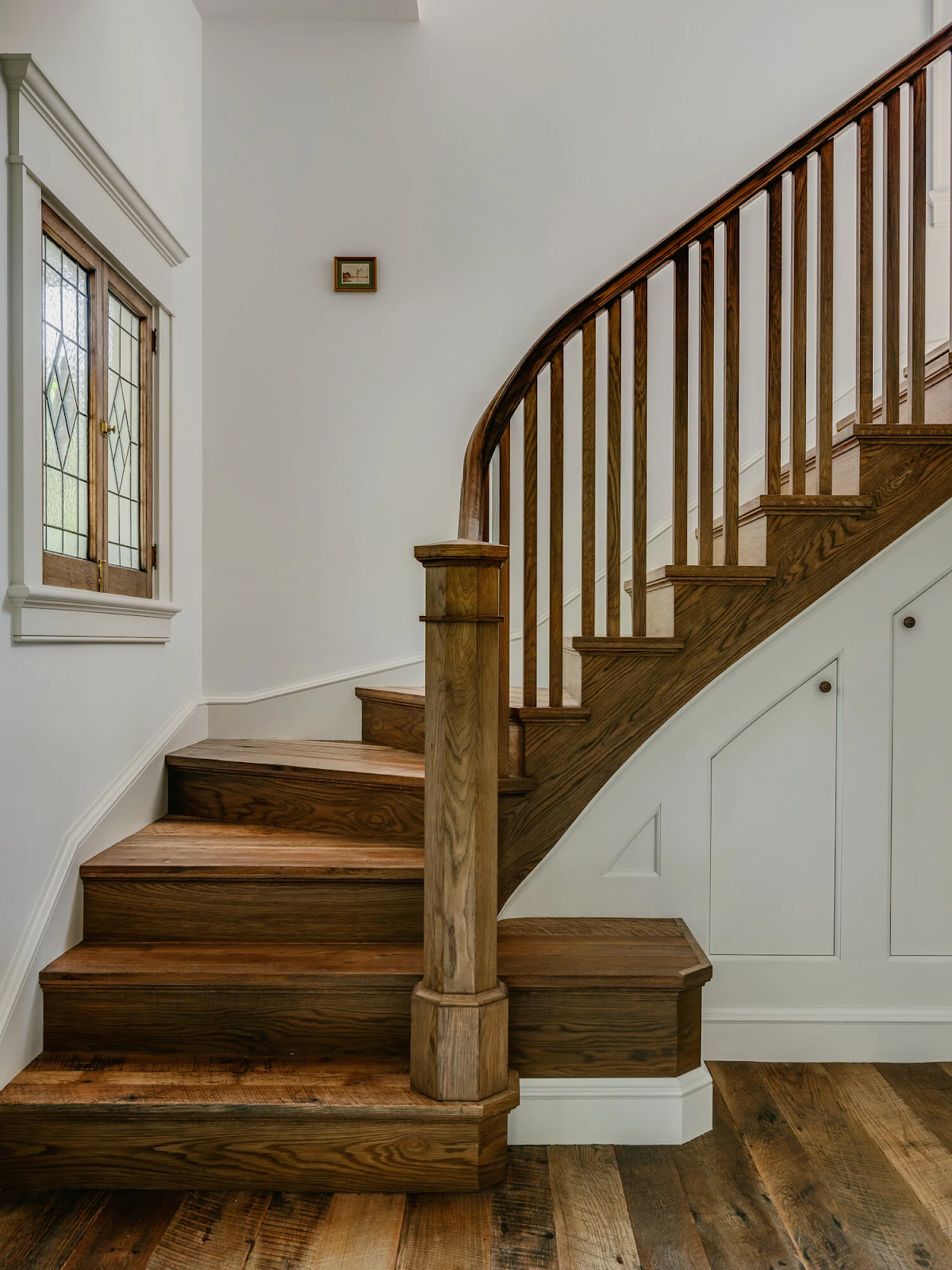 Custom staircase with centuries-old reclaimed oak treads and risers showing natural variation and patina in Palo Alto Craftsman home renovation