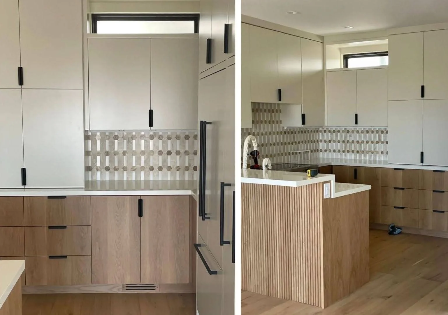 Kitchen under construction with cream upper cabinets, light oak lower cabinets, black hardware, a hexagon stone mosaic backsplash and a fluted oak peninsula
