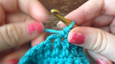 Gif of a crocheter making a single crochet square with a gold colored hook