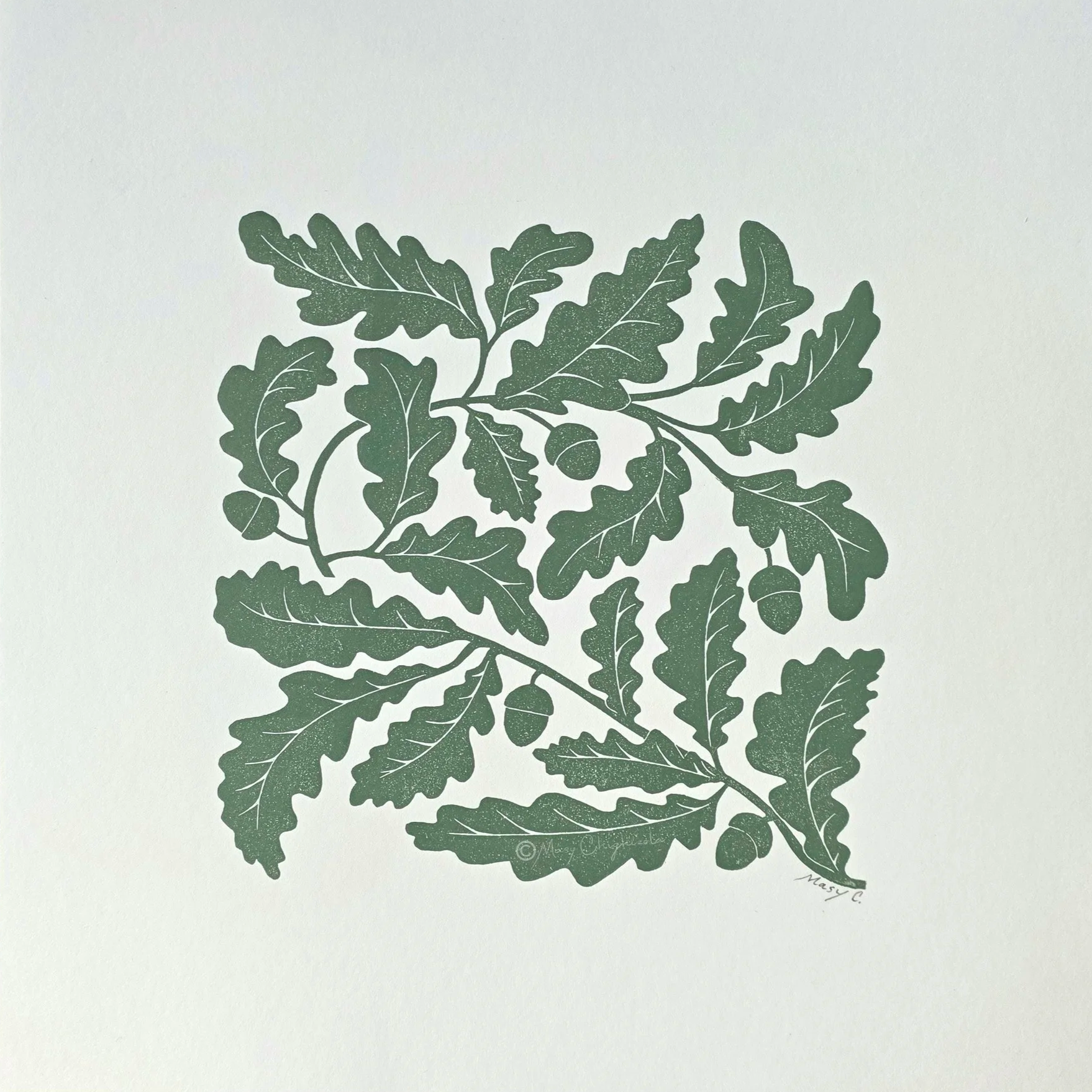 Nature-inspired 12x12 original block print featuring an oak tree branch with detailed leaves and acorns, hand printed in olive green ink on off-white fine art paper.