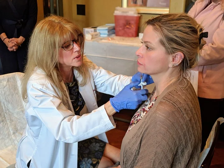 Dr. Roberts injecting a model at an aesthetic open house on December 8th, 2018.