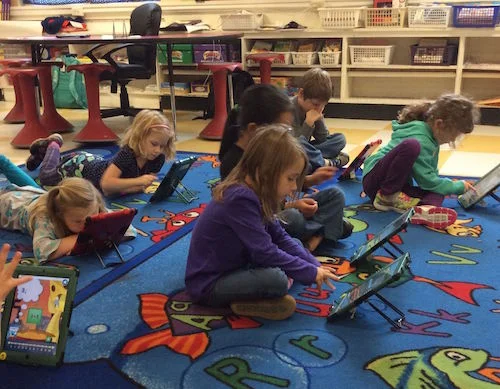mauri's kids on ipads small copy.jpg
