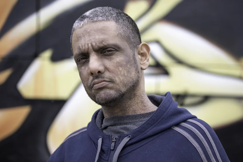  NYC artist&nbsp; Jonathan Meres &nbsp;in Bushwick, NY stands in front of his artwork. 