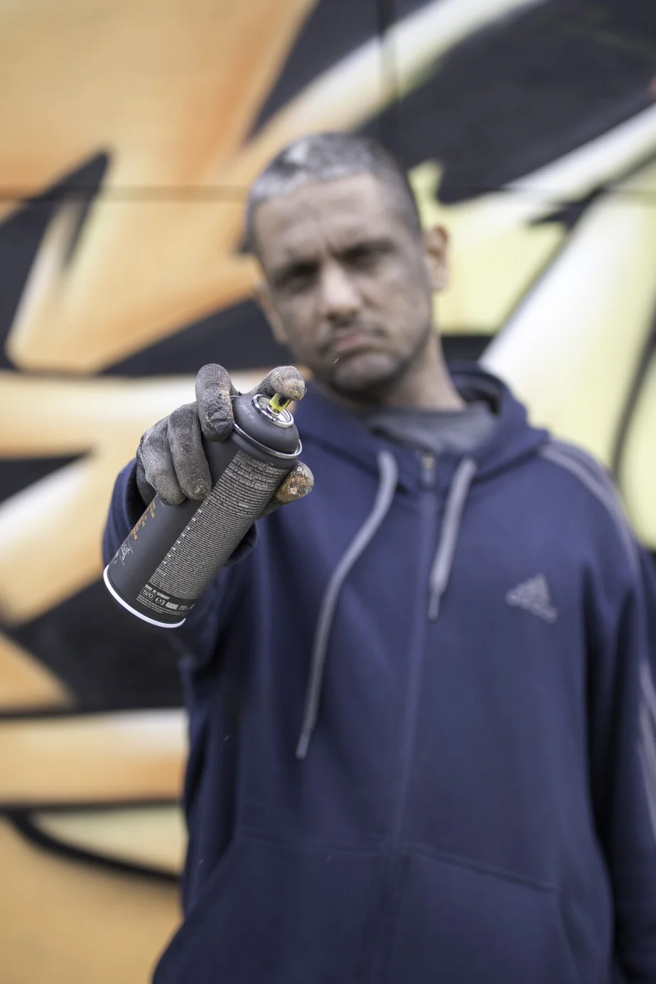  NYC artist  Jonathan Meres  in Bushwick, NY stands in front of his artwork. 