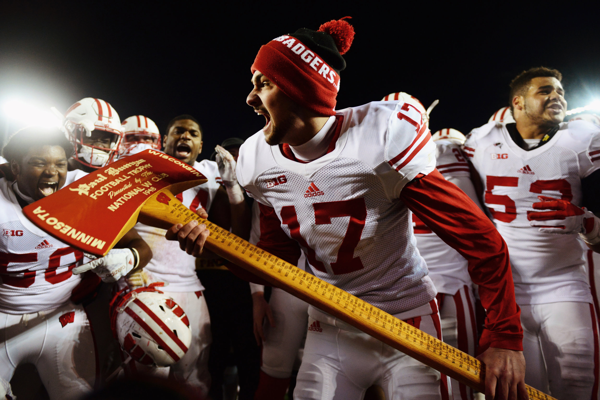 The University of Wisconsin-Madison football team celebrates, claiming Paul Bunyan's Axe for the twelfth consecutive year at TCF Bank Stadium on Saturday where the Gophers fell to the Badgers 31-21, Nov. 28, 2015.