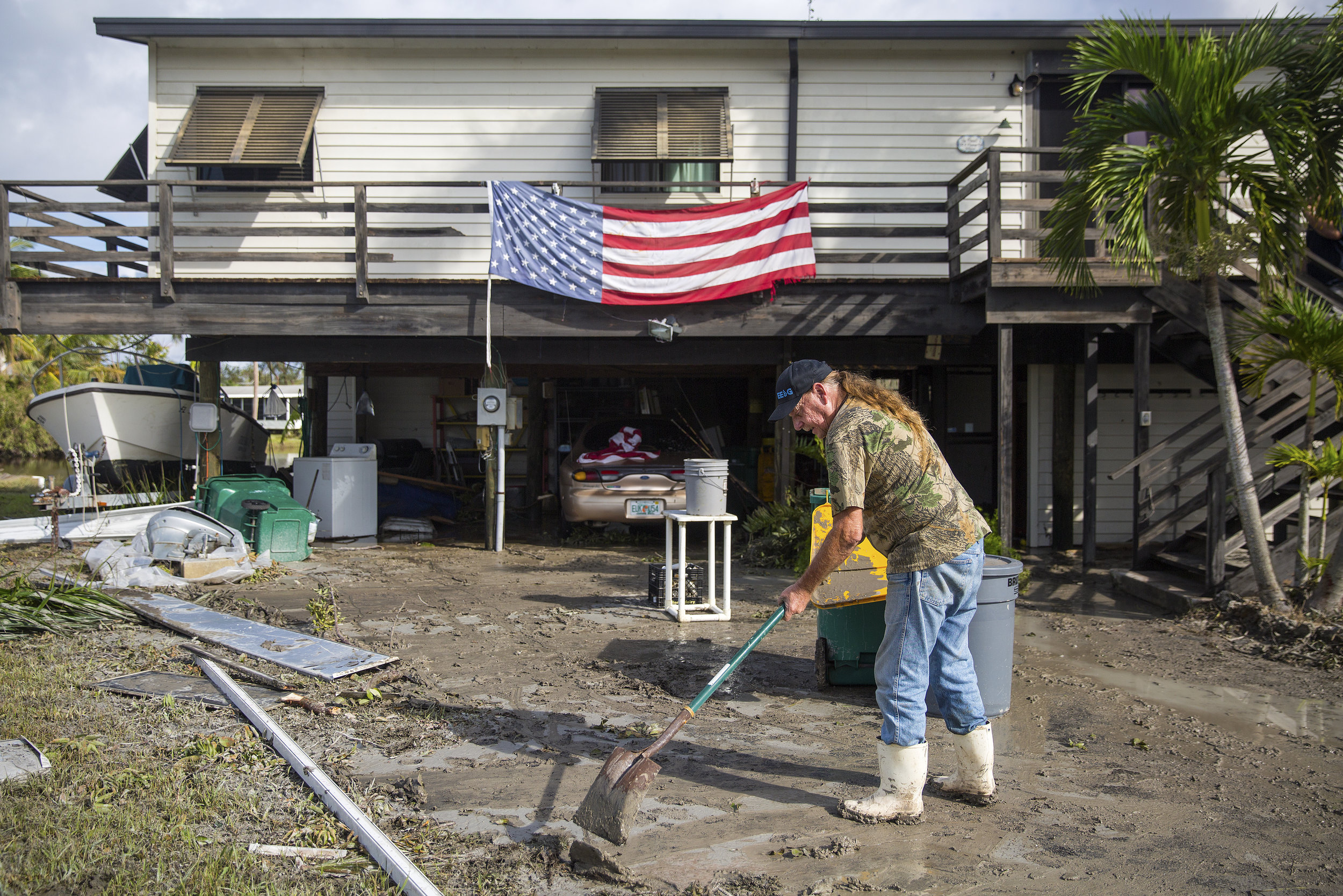  Harvey Pennell works to shovel a thick layer of mud from the driveway of his home in Plantation Island, an unincorporated area nearby Everglades City, as Collier County began picking up the pieces in the aftermath of Hurricane Irma on Tuesday, Septe