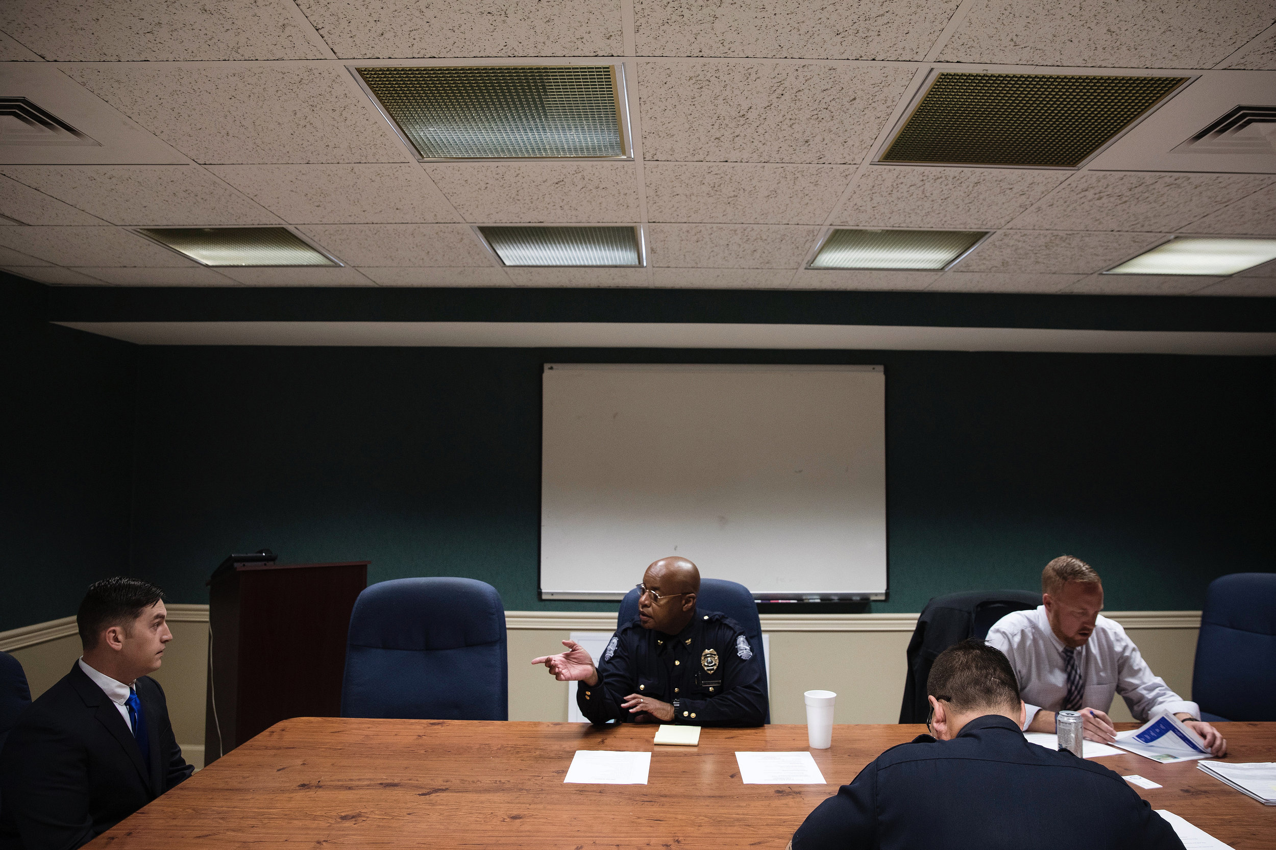  Wayne makes introductions before the start of an interview for a police officer. The department was seeking to fill three open positions to restore a full staff of 24. He sees hiring new officers as an opportunity to achieve his vision of diversity 