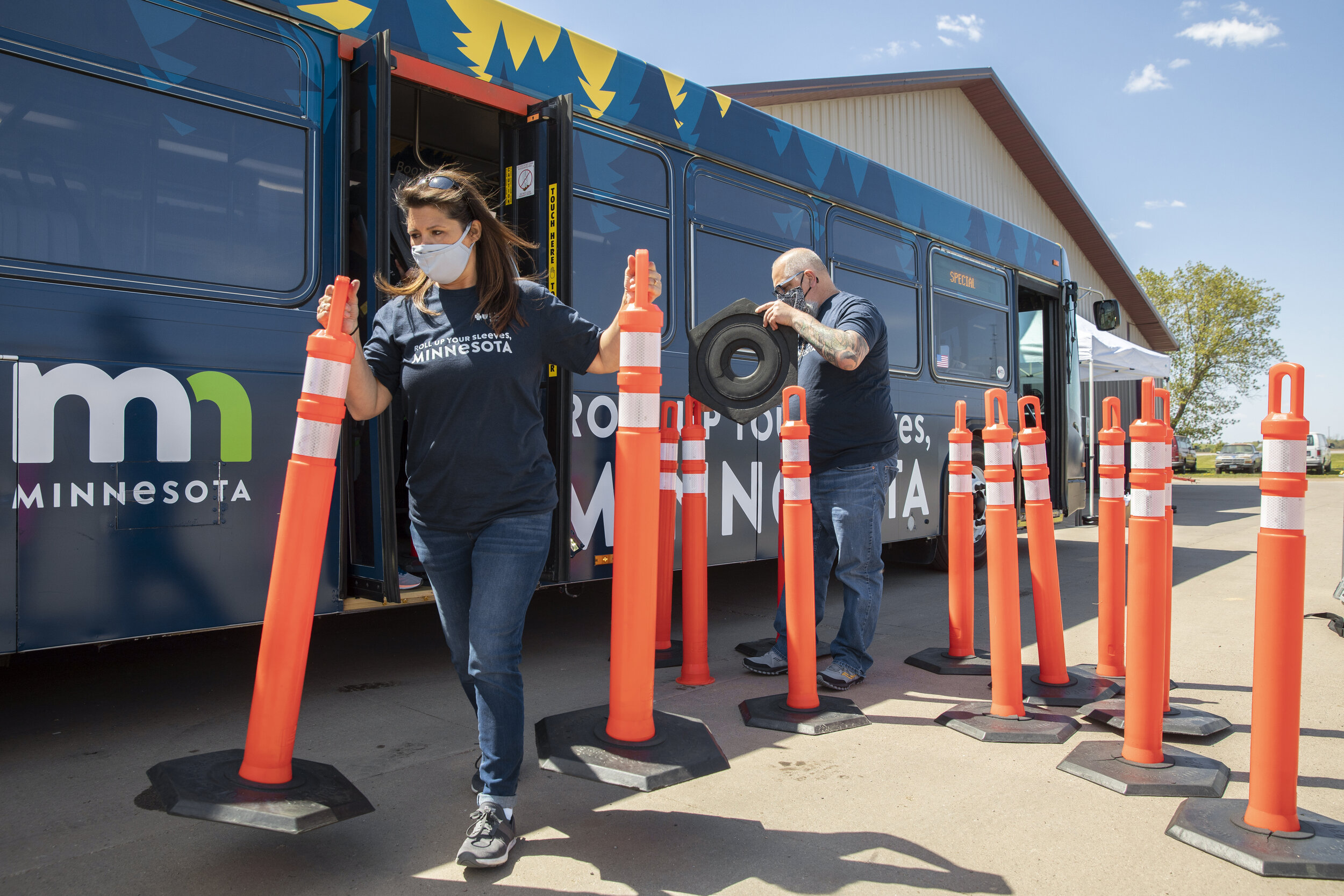  Blue Cross and Blue Shield of Minnesota staff volunteers Lisa Mittelstaedt, left, and Rashi McKinney work to set up the mobile Covid-19 vaccine clinic after arriving to Svihel Vegetable Farm in Foley, Minnesota on May 12, 2021. (Liam James Doyle for